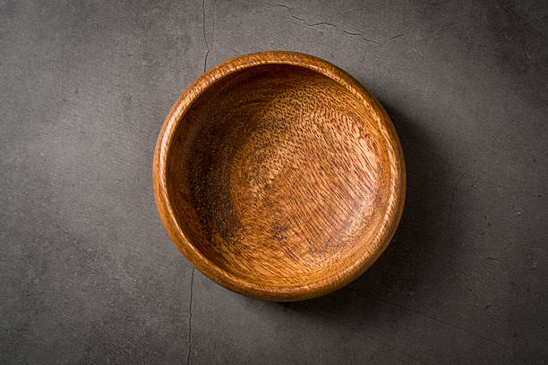 istock Top view of empty wooden nuts bowl on dark grey stone table 2207133422