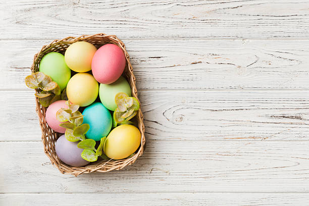 istock Multi colors Easter eggs in the woven basket on colored background . Pastel color Easter eggs. holiday concept with copy space 2207134815