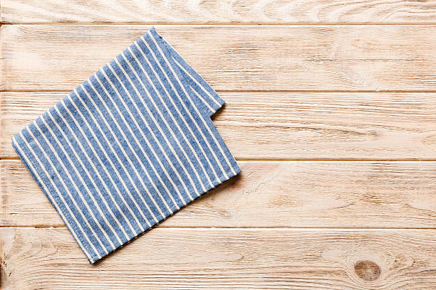 istock top view with blue kitchen napkin isolated on table background. Folded cloth for mockup with copy space, Flat lay. Minimal style 2207134918