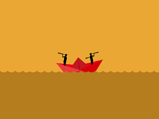 istock Different perspectives, Two businessmen on the paper boat look in different directions 2207138198