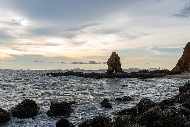 istock Boulders sticking out from smooth wavy sea. Tranquil scene. 2207138655