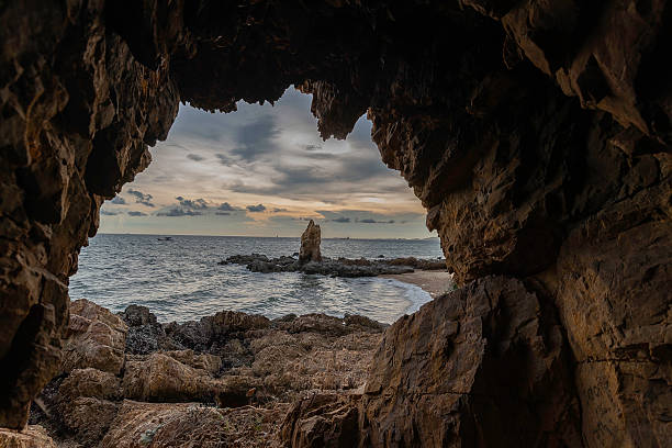 istock Boulders sticking out from smooth wavy sea. Tranquil scene. 2207138671