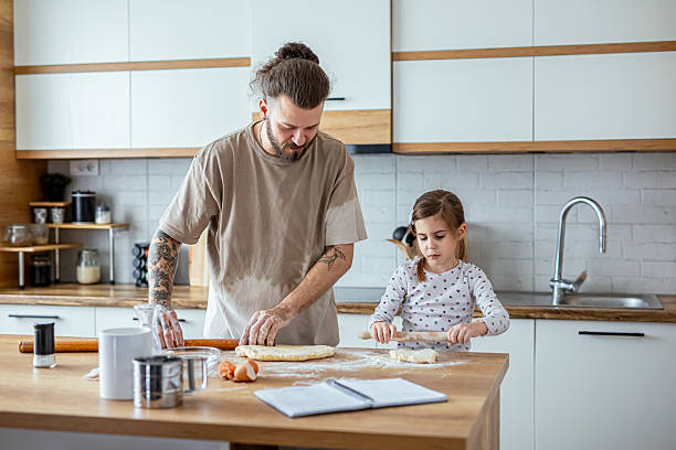 istock Happy father and daughter having fun while cooking pastry 2207141631
