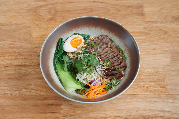 istock Noodles with sliced meat and vegetables 2207141974