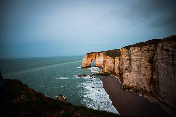 Expansive coastal scene showcasing dramatic white chalk cliffs meeting the vast blue ocean. The breathtaking contrast between land and sea captures the raw beauty of nature. Ideal for travel, exploration, and landscape themes