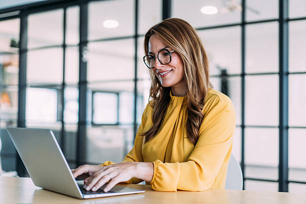 istock Successful businesswoman in modern office working on laptop. 2207144028