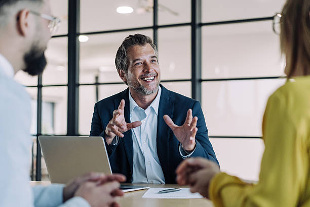 istock Group of business persons talking in the office. 2207144029