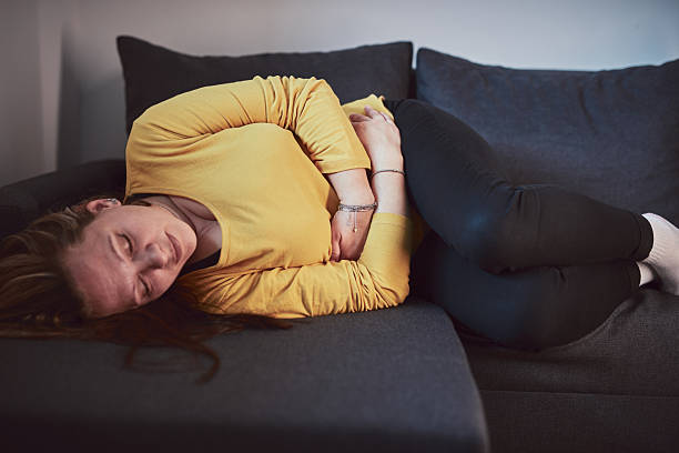 istock Woman with strong stomach ache, menstrual and digestive issues at home. 2207144364