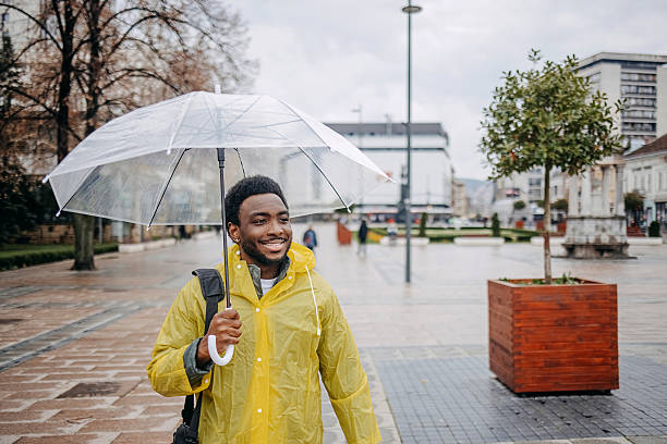 istock Man going to work walking outside on rainy day 2207145534