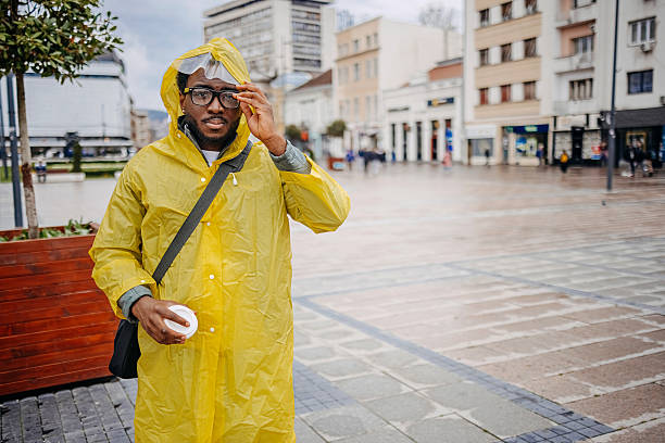 Musky fisherman wearing life jacket, and waterproof rain jacket in winter fishing