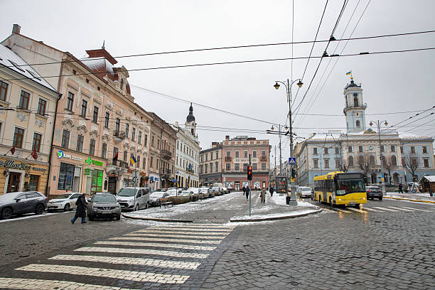 Chernivtsi, Ukraine - December 24, 2024: People walk along Central Square in downtown. Chernivtsi is the capital of historic region of Bukovina, which is now divided between Romania and Ukraine.