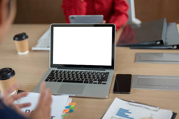 A well-organized office workspace showcases laptops and financial documents, illustrating a productive environment for collaborative work and planning.
