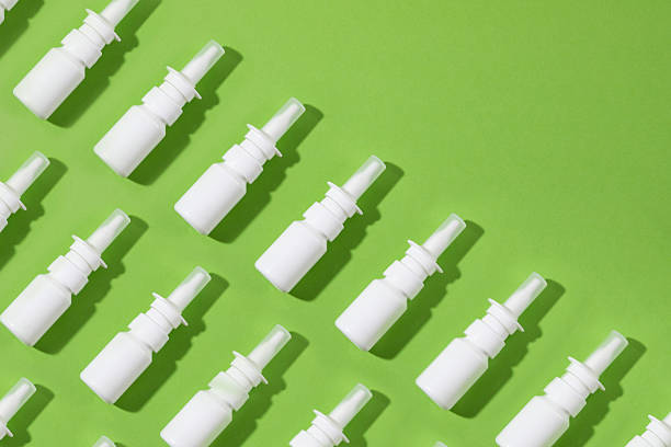 Nose spray in a row on green colored background