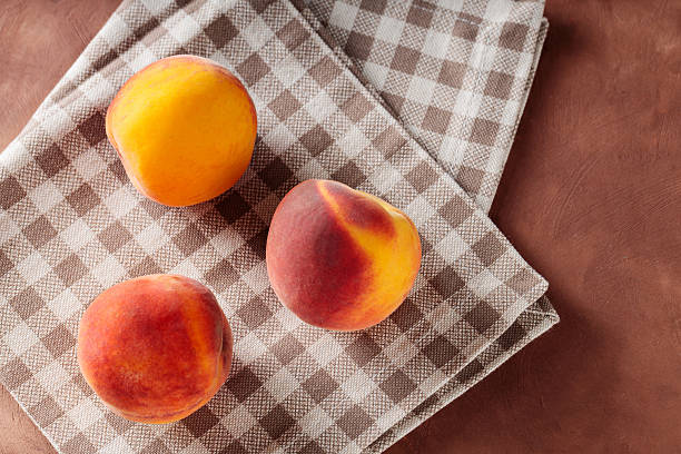 Ripe Peaches on Beige Linen Napkin