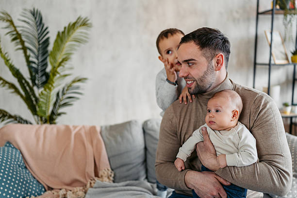 istock Young Father Playing With His Two Young Kids In An Apartment 2207147529
