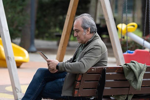 Senior Man Using a Tablet in the Park
