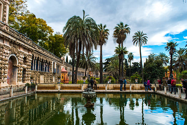 Seville, Spain - Mar 21, 2016: Visitors exploring the beautiful gardens at the Real Alcazar.