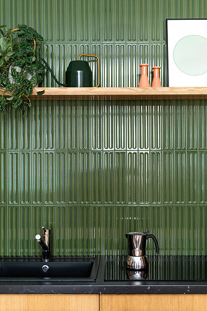 istock Modern kitchen design featuring green tiled backsplash and wooden details 2207149988