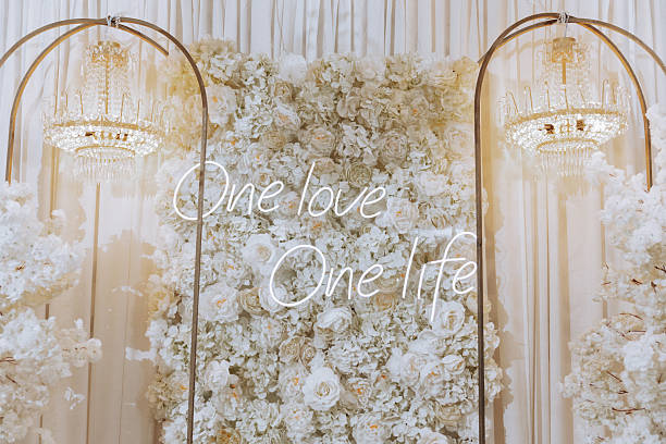 istock A white floral wall with a neon sign that reads 