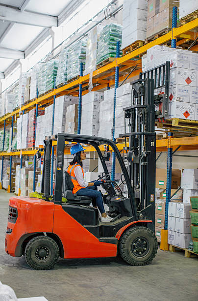 istock Female warehouse worker operating forklift in industrial storage facility. 2207151240