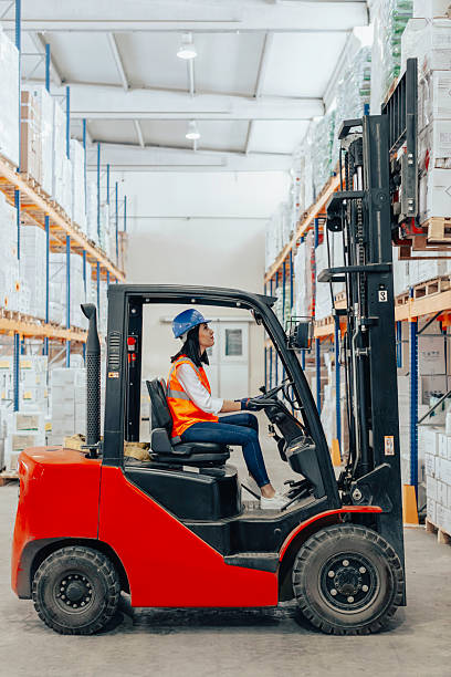 istock Female warehouse worker operating forklift in industrial storage facility. 2207151267