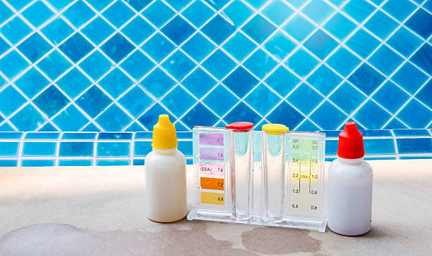 istock Liquid water testing test kit on swimming pool edge over clear water background 2207151903