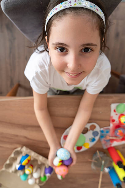 istock Happy little girl having fun with Easter eggs 2207151960