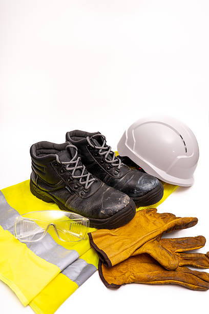 istock Safety gear protecting workers, including hard hats, protective gloves, and high-visibility vests across industrial workplace settings 2207153509