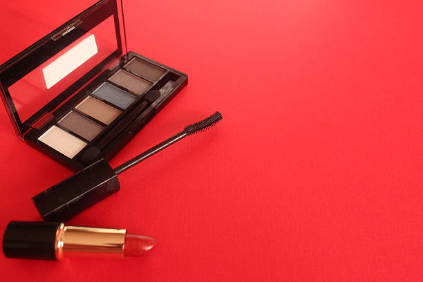 Mascara Eye Shadow Eyeshadow Palette Mascara on a Bright Red Background with Space for Text Copyspace.