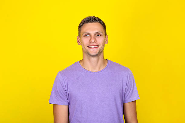 istock Portrait of young man on yellow background 2207156893