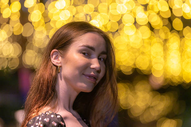 Young Russian woman portrait with light effect background at night.