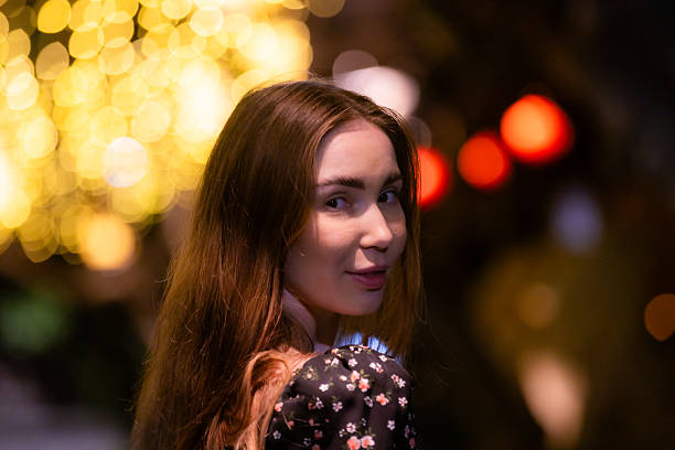 Young Russian woman portrait with light effect background at night.