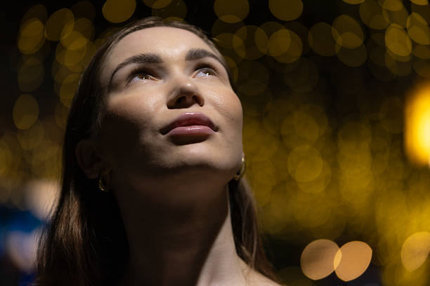 Young Russian woman portrait with light effect background at night.