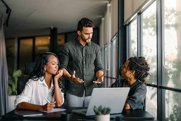 istock Colleagues arguing at workplace, executives disagree about papers, found error in contract 2207159777
