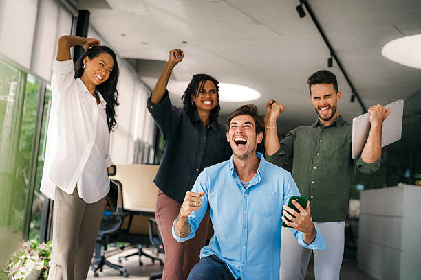 istock Overjoyed young multiethnic colleagues celebrating shared corporate success or goal achievement 2207160506