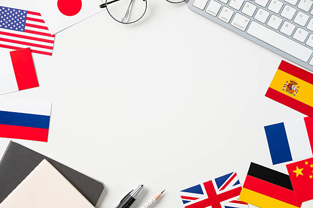 istock White workspace with country flags, keyboard, and stationery. Language school, education concept. 2207161346