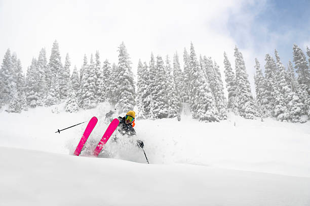 istock Skier descends mountain in fresh powder snow 2207161396