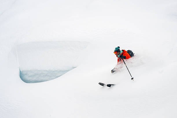 istock Skier descends mountain in fresh powder snow 2207161625