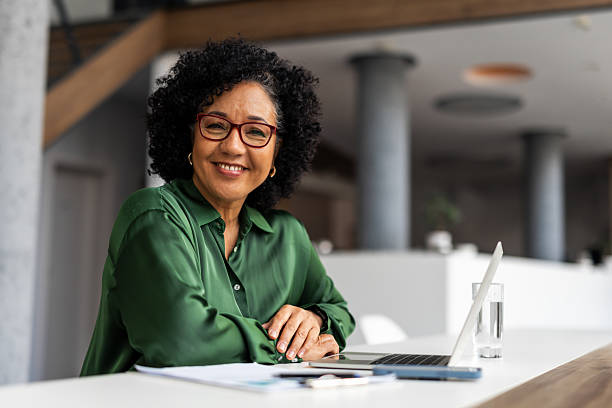 istock Confident Professional Woman Smiling at Desk in Modern Office Setting 2207162082