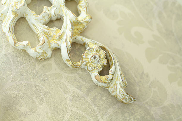istock Elegant wooden white and gold pattern hanging on retro wall background 2207163468
