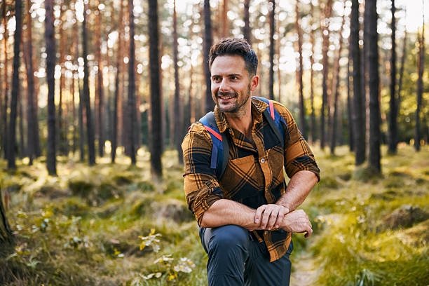istock Portrait of handsome man hiking alone in forest 2207163705