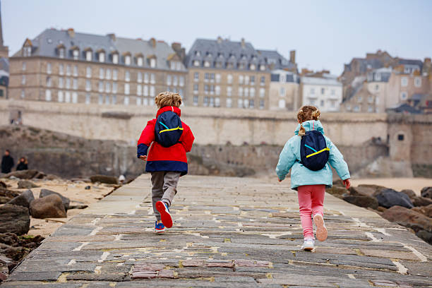 istock Two happy children run on a seaside stone pathway in Saint-Malo 2207164241