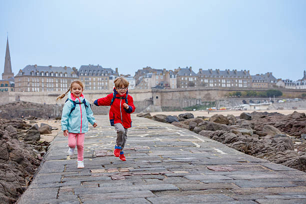 istock Children enjoying joyful run on a seaside walkway in Saint-Malo 2207164264