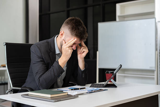 istock Young stressed caucasian businessman working in the office. 2207164354