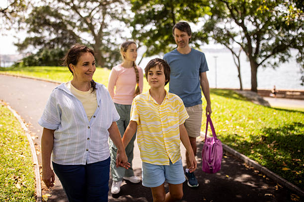 istock Family Enjoying a Walk in the Park 2207166659