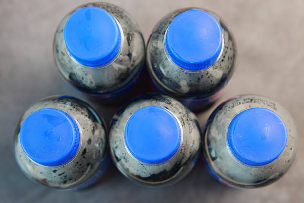 There are five bottles featuring blue caps neatly organized in a circular arrangement