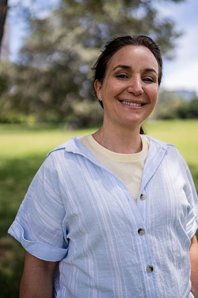 istock Woman Embracing the Outdoors in the Park 2207167766