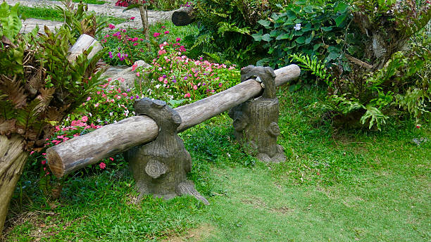 A small flower garden on Cape Cod features an unusual bird house and bird bath