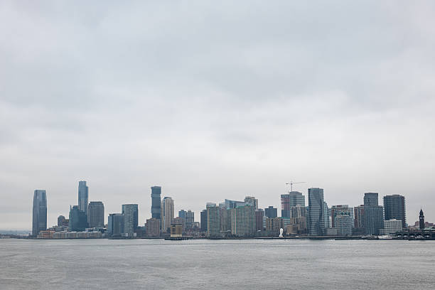 istock Overcast City Skyline Across Rippling Water 2207170170