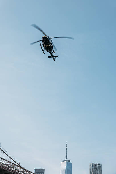 istock Helicopter Flying Over Iconic Bridge with City Skyline 2207170890